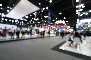 Blurred, defocused background of public event exhibition hall. Business trade show or commercial activity concept